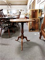 Lot 452 - An elm circular tripod table.