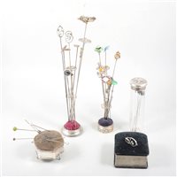 Lot 190 - Two silver hat pin stands with hat pins - to include an Irish silver circular Celtic design 34mm diameter by Wakely & Wheeler hallmarked Dublin 1911, Charles Horner bead and tube pins