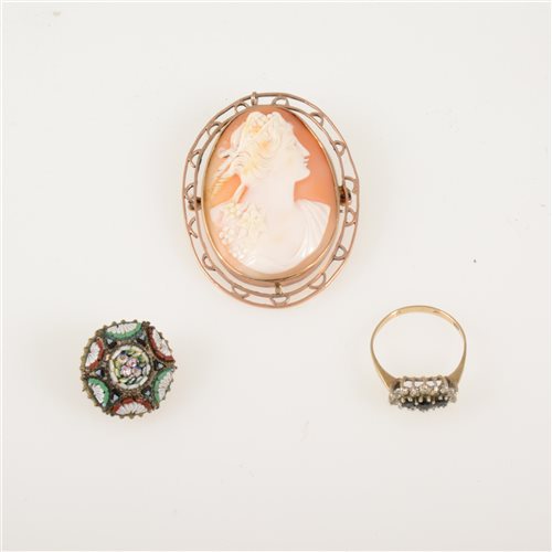 Lot 214 - An oval carved shell cameo brooch in a yellow metal frame overall 50mm x 40mm, 16mm micro mosaic brooch, 9 carat ring set with cubic zirconia (3)