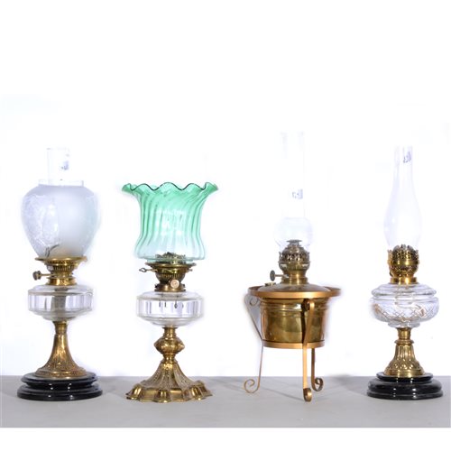 Lot 168 - Four oil lamps, to include Hink's No. 2, green wrythen fluted shade, clear transparent reservoir, brass column and base in hexagonal-style shape, no chimney, 46cm... (4)