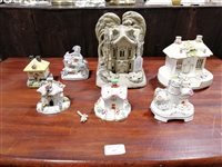 Lot 73 - A collection of eleven Staffordshire pottery cottages and pastille burners.