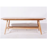 Lot 614 - An elm and beech coffee table with magazine rack undertier by Ercol