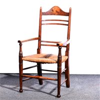 Lot 409 - An Arts and Crafts oak and inlaid rush seated ladder back chair, circa 1890.