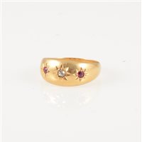 Lot 244 - A ruby and diamond dress ring, the old cut diamond and two rubies star gypsy set in an 18 carat yellow gold tapered band, hallmarked Chester 1917, approximate weight 3.3gms, ring size O.