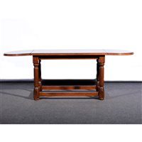 Lot 428 - An oak drop-leaf coffee table, rounded ends, turned legs, plain stretchers, minimum width 90cm.