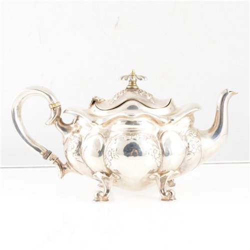 Lot 219 - An Edwardian silver bachelor tea pot by Henry Williamson Ltd, of lobed oval form, embossed floral decoration, raised on four scroll feet, Hallmarked Birmingham 1907