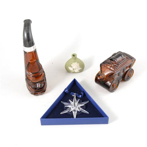 Lot 141 - A collection of press-moulded glass bottles, glass paperweights, and a Swarovski ornament.
