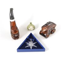 Lot 141 - A collection of press-moulded glass bottles, glass paperweights, and a Swarovski ornament.