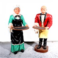 Lot 160 - A 19th Century pewter hot water meat platter, two vintage enamel advertising signs and two dumb waiters carved into the figures of an elderly couple
