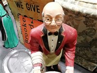 Lot 160 - A 19th Century pewter hot water meat platter, two vintage enamel advertising signs and two dumb waiters carved into the figures of an elderly couple