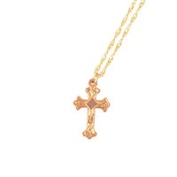 Lot 266 - A rose metal cross, 25mm, marked 9ct on a modern 9 carat yellow gold twisted flat curb link chain 40cm long, total weight approximately 4.5gms.