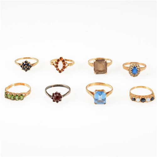 Lot 239 - Eight gemset dress rings, garnet, sapphire, opal, smoky quartz, synthetic blue and white stones, CZ, one silver set, the rest hallmarked 9 carat gold or marked 9ct. ring sizes M-P. (8)