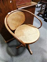 Lot 426 - A Thonet bentwood swivel chair, with cane seat and back, width 57cm.