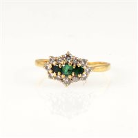 Lot 242 - An emerald and diamond cluster ring, three small emeralds claw set horizontally and surrounded by twelve brilliant cut diamonds in an 18 carat yellow and white gold mount