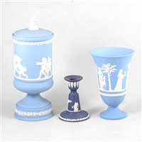 Lot 57 - Wedgwood blue jasperware pedestal covered vase, 30cm, a flared vase, small circular bowl and a candlestick, (4).