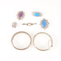 Lot 290 - Two silver hollow half hinged bangles,12.5mm and 13mm wide, scroll engraved decoration to front, five silver brooches to include an oval cabochon cut blue chalcedony brooch hallmarked London 1988