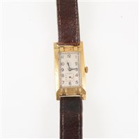 Lot 198 - A lady's/gentleman's vintage wrist watch, rectangular cream arabic dial with subsidiary seconds dial in a yellow metal case 35mm x 20mm marked 18 .75. 45209