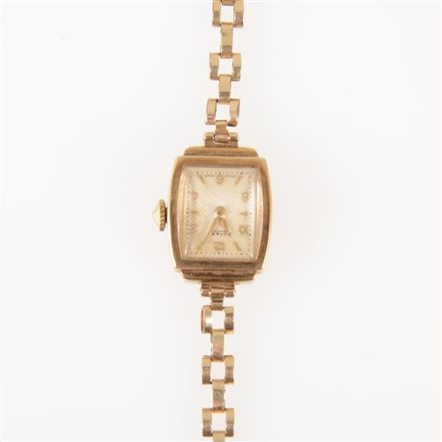 Lot 293 - Rotary - a lady's 9 carat yellow gold bracelet watch, rectangular light champagne baton dial with quarter arabics in a 9 carat yellow gold case