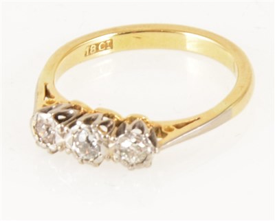 Lot 174 - A diamond three stone ring, the old brilliant cut stones illusion set in a yellow and white metal traditional three stone mount, shank marked 18ct, gross weight approximately 3gms, ring size K.