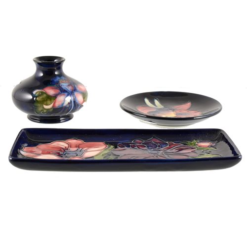 Lot 532 - Three items of Moorcroft Pottery, including an 'Orchid' design coaster, 'Anemone' tray, and another vase..