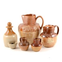 Lot 31 - Doulton and other stoneware pottery, a Fulham Pottery 22cm salt glazed harvest jug, three Doulton harvest jugs 16cm,14.5cm and 9cm