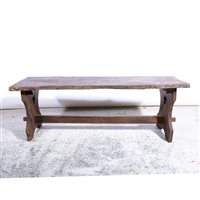 Lot 431 - A natural elm coffee table, shaped top, trestle base, length 124cm.