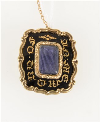 Lot 185 - A Victorian mourning brooch, the yellow metal rectangular brooch having a black and gilt border reading "In Memory Of", vacant hair compartment to centre, overall 28mm x 25mm