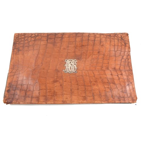 Lot 80 - An early 20th Century desk top stationery folder with crocodile cover produced in Vienna having a silver coloured monogram "AHS" to centre