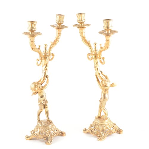 Lot 119 - A pair of continental lacquered brass twin-light candelabra, similarly designed, 42cm (2)