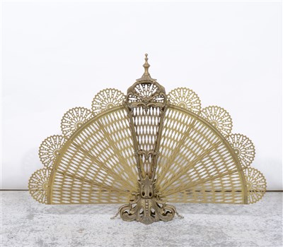 Lot 317 - A brass folding pierced fan design firescreen 60cm high.
