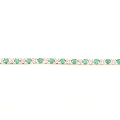Lot 262 - An emerald and diamond line bracelet