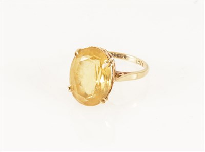 Lot 180 - A citrine dress ring, the oval mixed cut stone 16mm x 12mm, set by four double claws in a 9 carat yellow gold mount, hallmarked Birmingham 1963, ring size O.