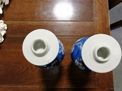 Lot 8 - Pair of Chinese blue and white covered vases, bearing four character marks, baluster shape, with domed lids, decorated with blossom, 34cm.