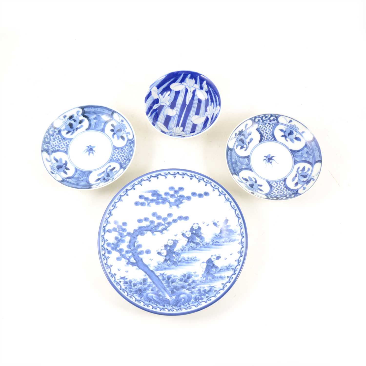 Lot 52 - A collection of Japanese blue and white plates and dishes, to include two with dragon design to centre, 21.8cm diameter, and a set of three with floral design, 14.8cm.