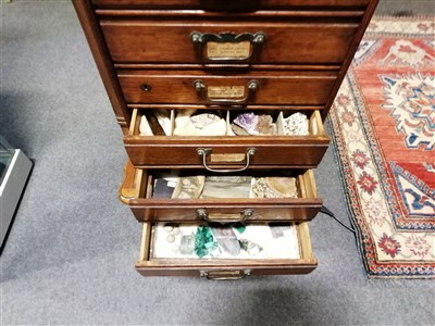 Lot 213 - A collectors cabinet by Henry Stone & Son, Banbury, 31cm x 45cm x 26cm, six drawers containing a quantity of uncut gemstone and polished fossilised material specimens