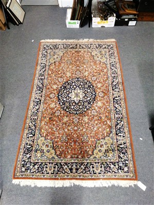 Lot 469 - Indian Persian pattern rug, central medallion on a flower filled rust-coloured ground, narrow border within guards, 210 x 130cm