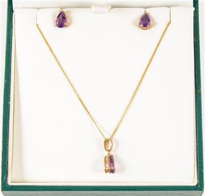 Lot 266 - An amethyst pendant and earring suite, the faceted pear shaped stones claw set