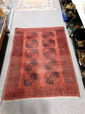 Lot 473 - Afghan rug, two rows of five elephant foot guls on a red field, multi-bordered,180 x 136cm.