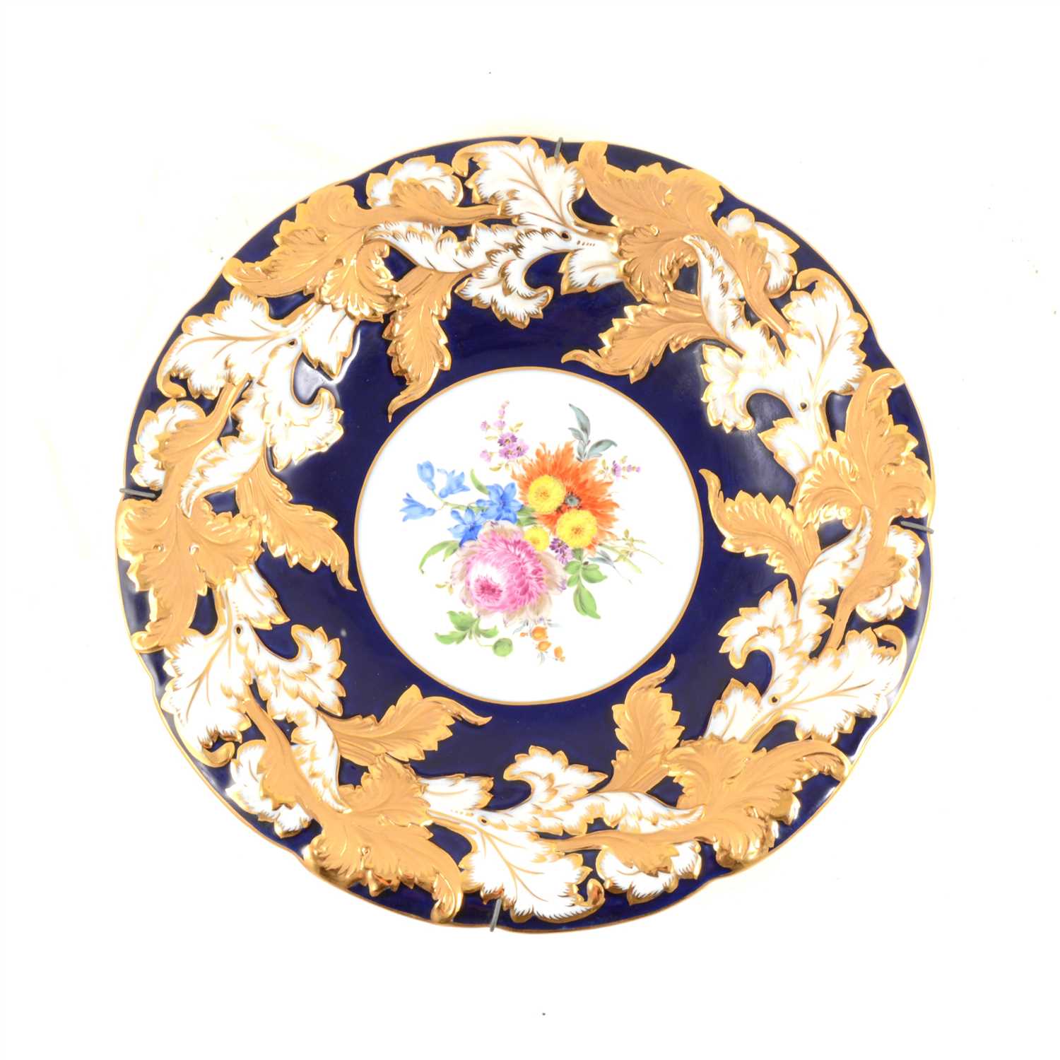 Lot 42 - A Meissen hand painted dish with floral centre, cobalt blue border with gilded acanthus leaf decoration around scalloped rim, impressed C113,  30cm.