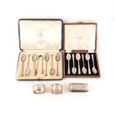 Lot 219 - A cased set of six silver teaspoons with sugar tongs London 1929, five silver napkin rings, ivorine napkin ring with initial "K" and a set of EPNS coffee spoons.