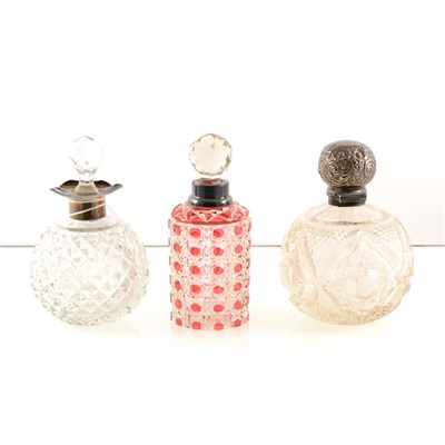 Lot 211 - Three Edwardian cut-glass spherical-shaped scent bottle, with silver mounts