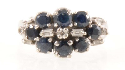 Lot 199 - A multi stone sapphire and diamond cluster ring.
