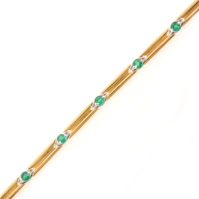 Lot 261 - An 18 carat gold bracelet set with seven emeralds.