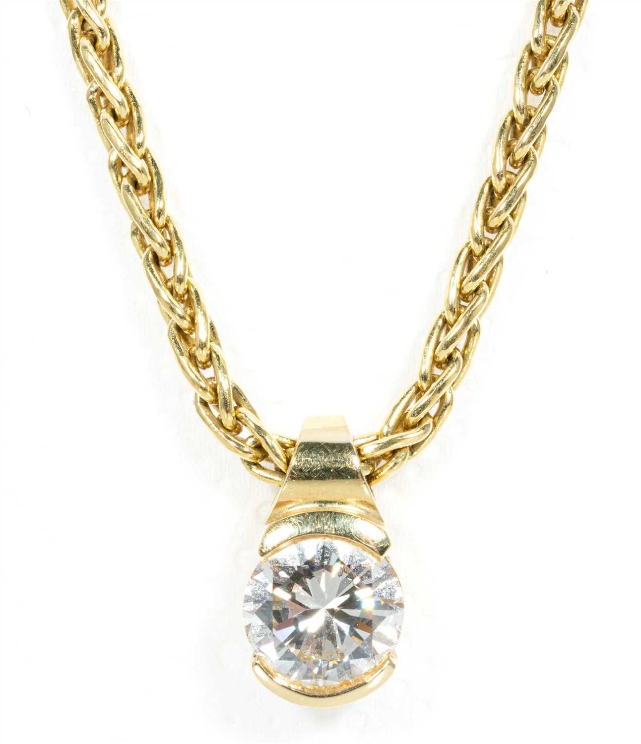 Lot 214 - A diamond solitaire pendant and chain.
