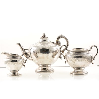 Lot 238 - A silver teapot by A B Savory & Sons (William Smily), with chased decoration, fruit finial, a hinged lid and a scroll handle, London 1863, 19.5cm high, a silver twin-handled jug by the same maker
