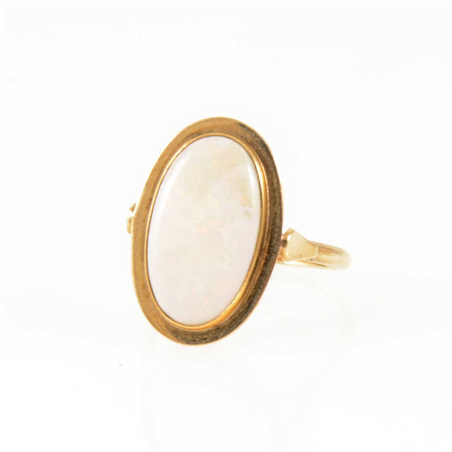 Lot 255 - An opal dress ring, the oval cabochon cut stone.