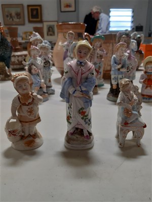 Lot 5 - Pair of German porcelain figures of child musicians, and twelve others.