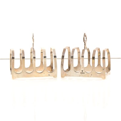 Lot 235 - A pair of silver toast racks by Harrods Ltd, four divisions, Sheffield 1937, 7.3cm high, total approx. weight 3.4oz.