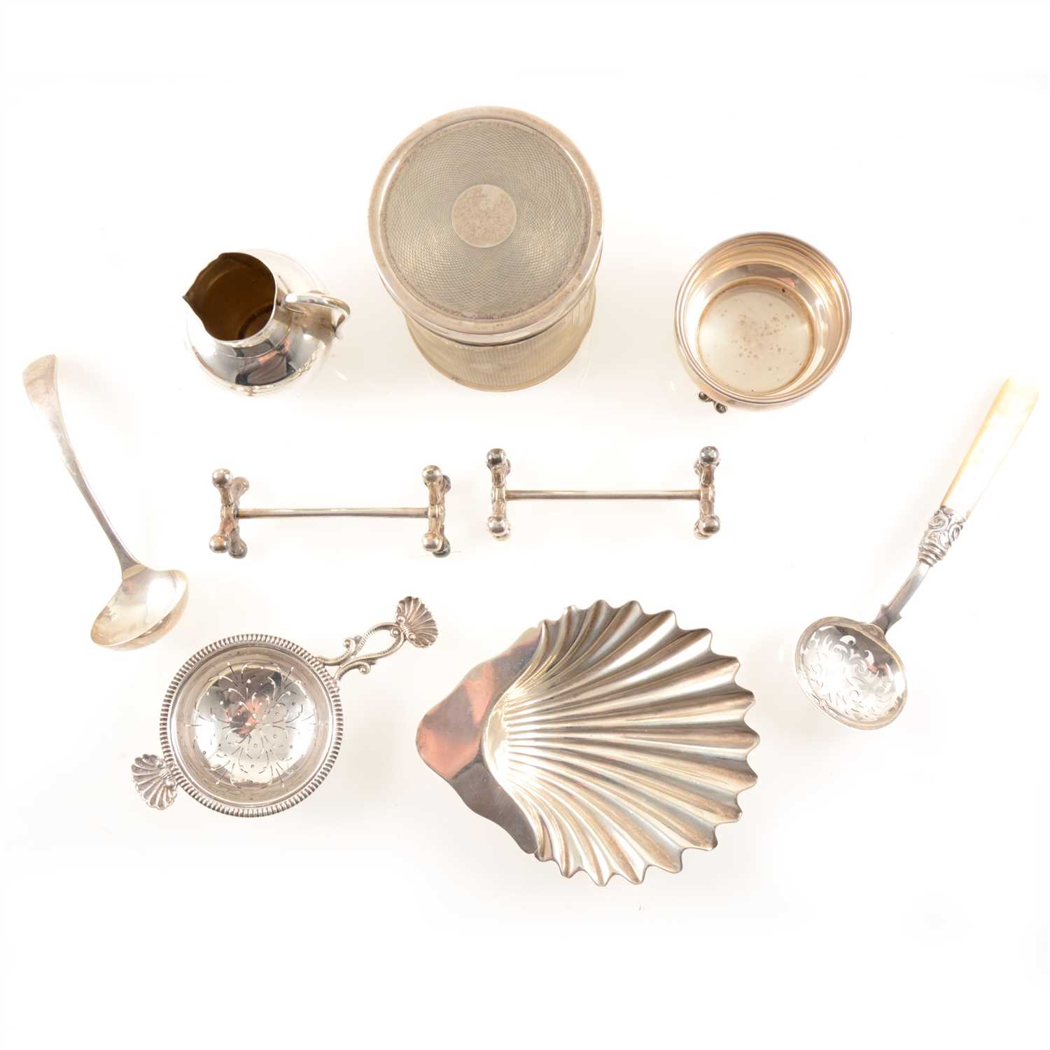 Lot 216 - A selection of silver items, to include an engine-turned jar and lid by Mappin & Webb Ltd, Sheffield 1934, a small jug by George Unite & Sons, Birmingham 1890