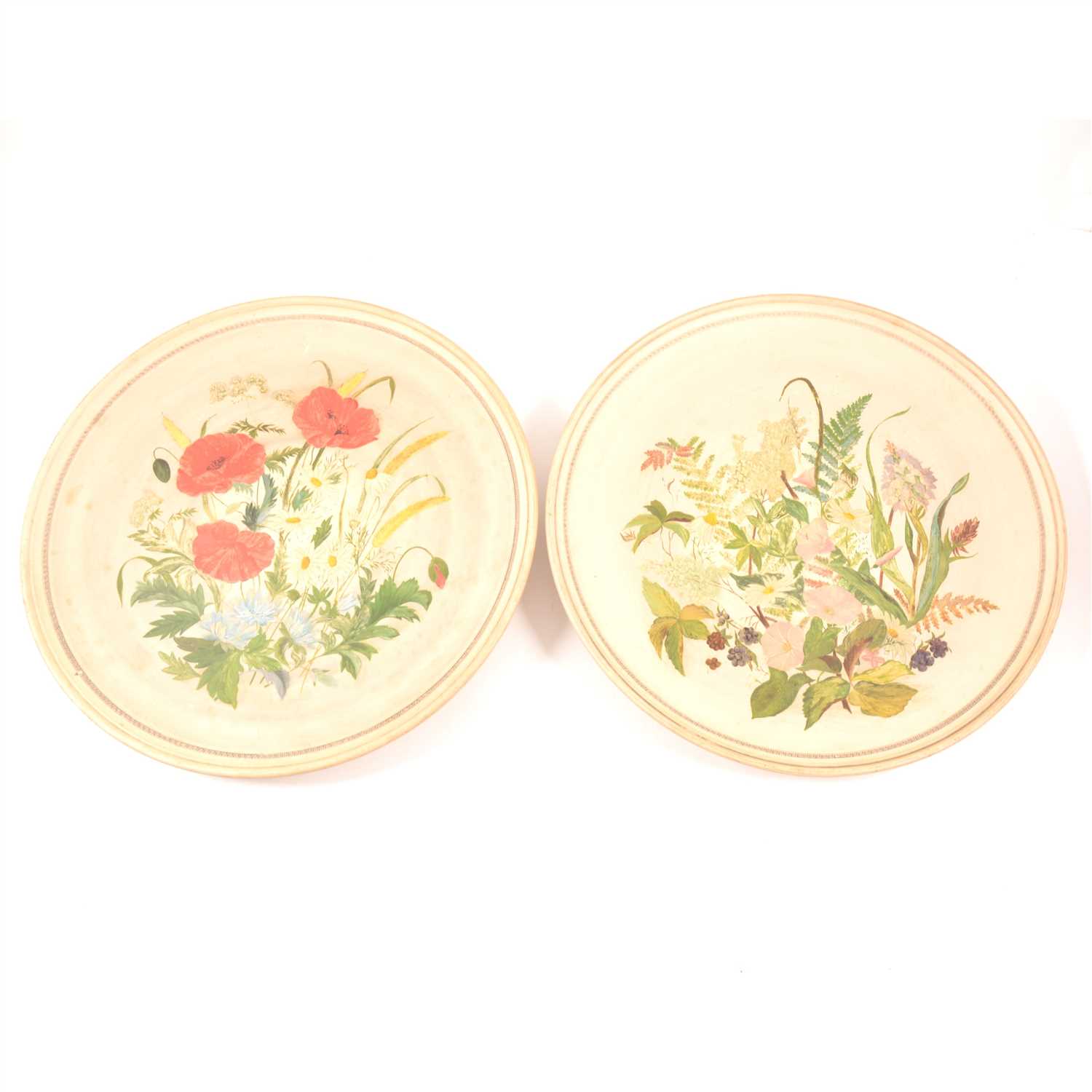 Lot 75 - A pair of buff coloured circular plaques, P. Ipsen, each painted with spring flowers, diameter 37cm.